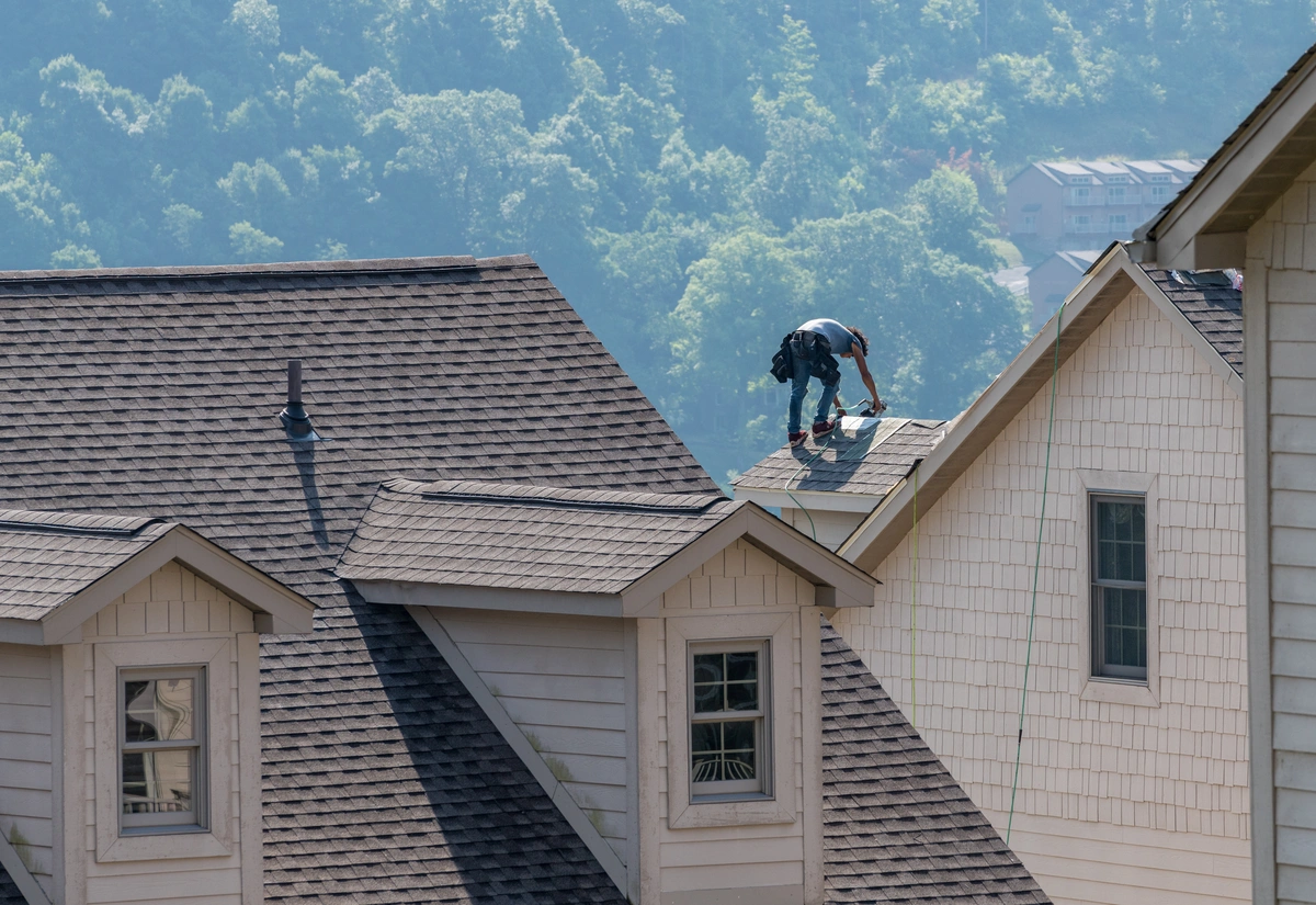 workers repairing large building roofs